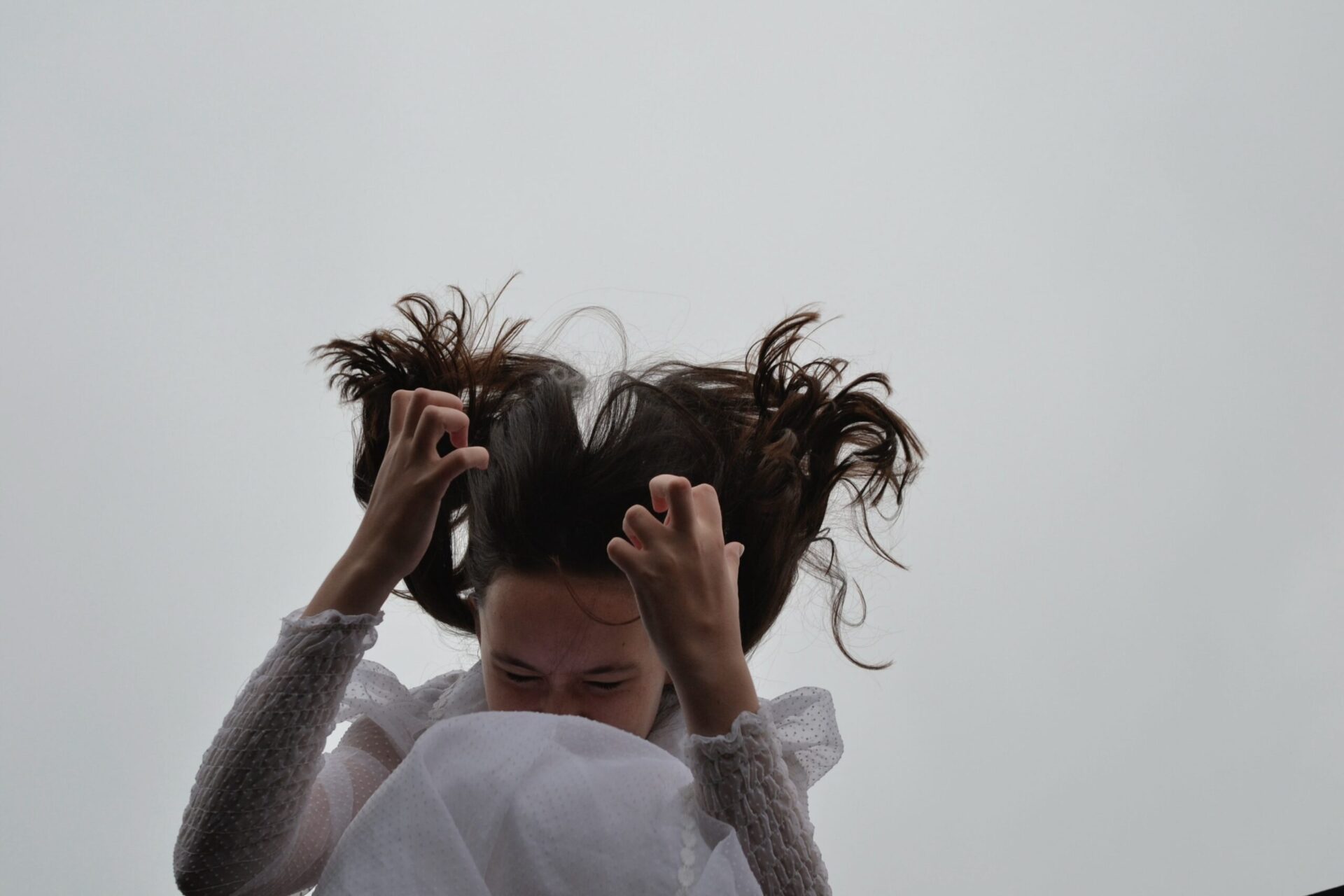 a woman appearing angry with fists tensed and her body jumping, seemingly displaying physical effects of anxiety and depression