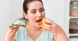 A hungry looking woman about to devour a "forbidden" food