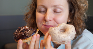 Food noise is real, as illustrated by the photo of a woman happily eating two donuts