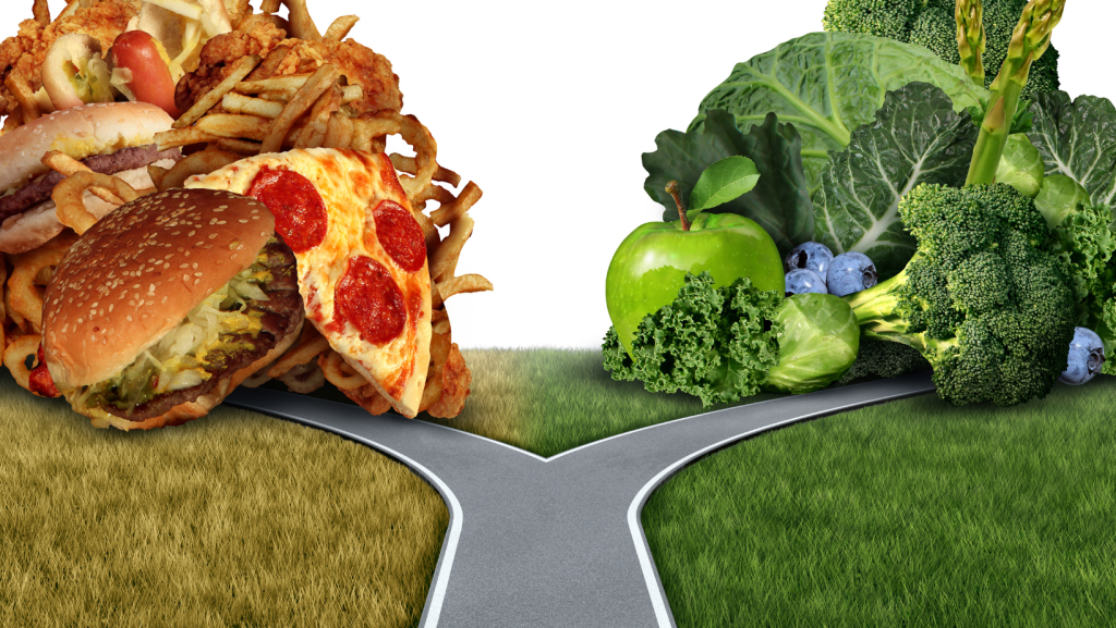 A "Y" in the road; on one side is pizza and onion rings and on the other is an apple and kale. Both are part of food noise.