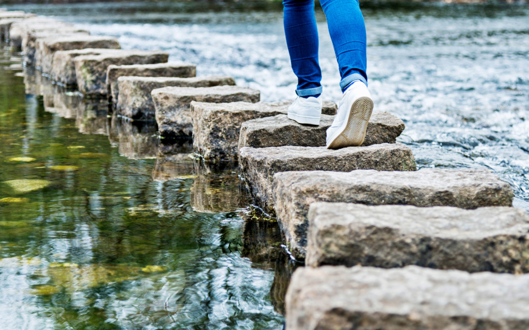 woman walking on stepping stones, suggesting she is moving away from Ozempic and choosing fact over fiction