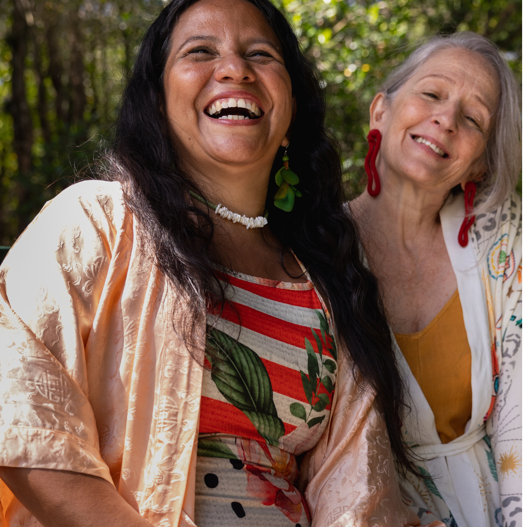 While outside, two middle aged women are talking and smiling